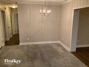 Charlotte house for rent - a empty living room with a chandelier and wood floor