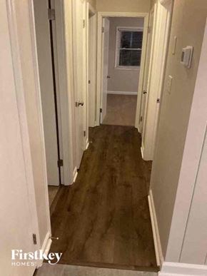 Charlotte house for rent - a hallway with white walls and a wood floor