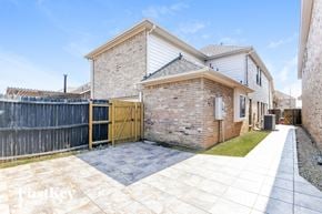 Grand Prairie house for rent - A house with a brick exterior and a wooden fence.