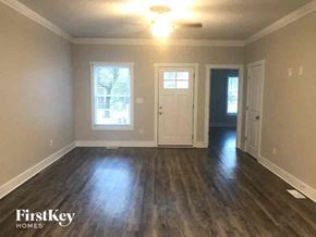 Monroe house for rent - an empty living room with a hard wood floor