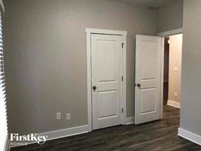Monroe house for rent - a living room with two white doors and a hallway