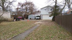 Louisville house for rent - a yard with a house and a truck parked in the driveway