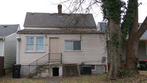 Louisville house for rent - a white house with a yard and a tree