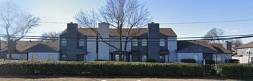 Dallas apartment for rent - a large house with a fence in front of it