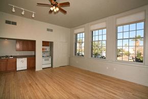 Ajo apartment for rent - an empty living room with a kitchen and a ceiling fan
