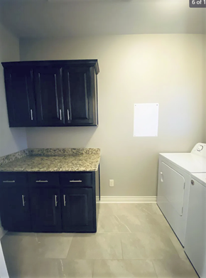 Tyler apartment for rent - A kitchen with black cabinets and a granite countertop.
