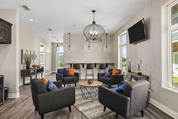 Tyler apartment for rent - A living room with grey couches and a chandelier.