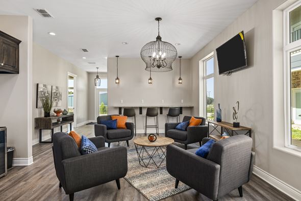 Tyler apartment for rent - A living room with grey couches and a chandelier.