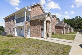 Tyler apartment for rent - A two-story brick house with a balcony on the upper floor.