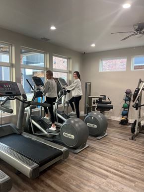 Tyler apartment for rent - Two people are exercising on treadmills in a gym.