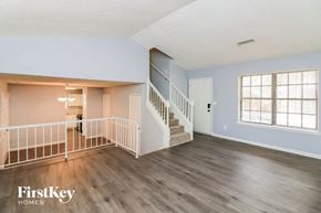 Stone Mountain house for rent - the living room and entryway of a house with wood floors and a staircase