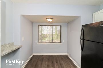 Stone Mountain house for rent - a small kitchen with a refrigerator and a window