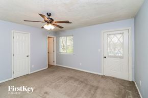 Stone Mountain house for rent - a bedroom with blue walls and a ceiling fan and a door
