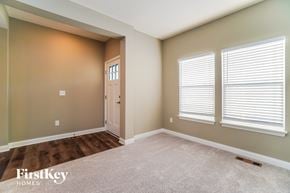 Lancaster house for rent - an empty room with a door and three windows