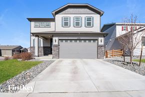 Aurora house for rent - a large house with a garage door in front of it