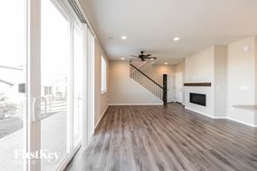 Aurora house for rent - a living room with a fireplace and a hallway with a staircase
