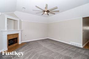 Oakland house for rent - A room with a fireplace and a ceiling fan.