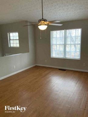 Clermont house for rent - A room with a ceiling fan and two windows.