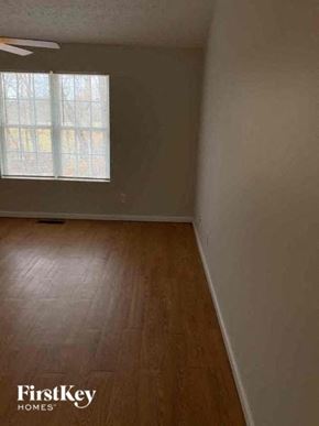Clermont house for rent - A room with wooden flooring and a window with blinds.