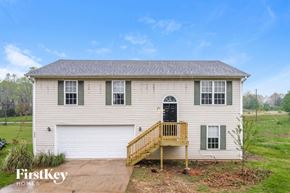Gainesville house for rent - the front of a white house with a porch and a black door