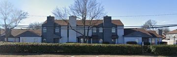 Dallas apartment for rent - a large white house with a fence in front of it