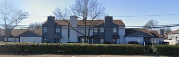 Dallas apartment for rent - a large house with a fence in front of it