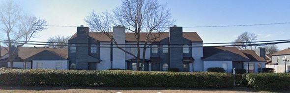 Dallas apartment for rent - A large house with a grey roof and white walls.