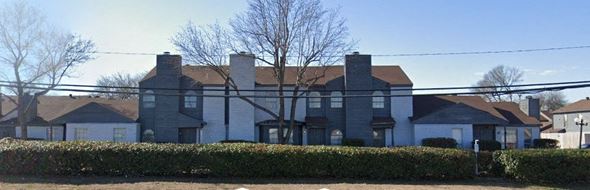 Dallas apartment for rent - A large house with a grey roof and a white fence.