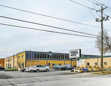 St. Paul apartment for rent - a large yellow building with cars parked in front of it