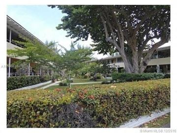 Bal Harbor house for rent - a view of a building with trees and bushes
