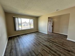 Manteca house for rent - A room with a window and wooden flooring.