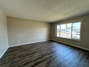 Manteca house for rent - A room with a window and wooden flooring.
