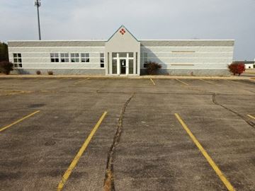 Stevens Point apartment for rent - A white building with a red triangle on the top left corner.