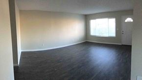 Manteca house for rent - A room with wooden flooring and a window with blinds.