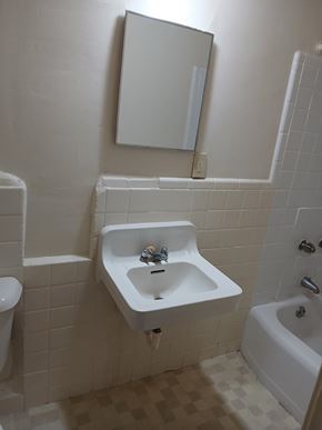 Louisville apartment for rent - A white sink in a white tiled bathroom.