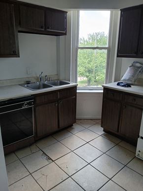 Louisville apartment for rent - an empty kitchen with a sink and a window