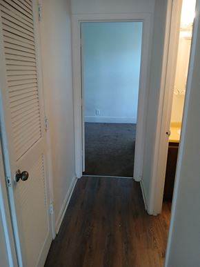 Louisville apartment for rent - a hallway with a door to a room with a carpeted floor