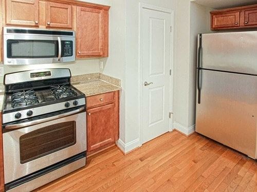 Piermont apartment for rent - A kitchen with wooden cabinets and a stainless steel refrigerator.