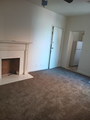 Louisville apartment for rent - an empty living room with a fireplace and a closet