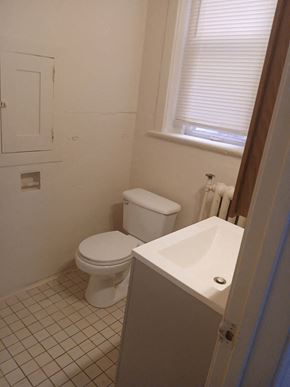 Louisville apartment for rent - a bathroom with a toilet and a sink and a window