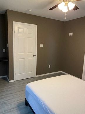Prairie View apartment for rent - a bedroom with a white bed and a white door