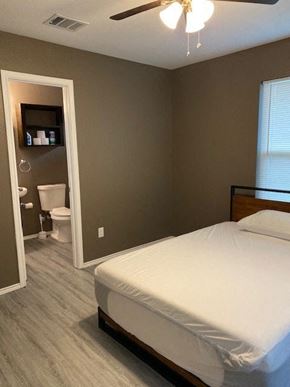 Prairie View apartment for rent - a bedroom with a bed and a bathroom with a toilet