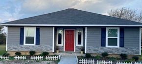 Prairie View apartment for rent - a blue and white house with a red door