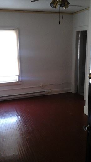 Louisville apartment for rent - an empty room with a wood floor and a window