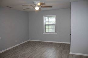 Petal house for rent - A room with a ceiling fan and a window.