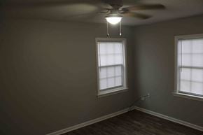 Petal house for rent - A room with a ceiling fan and two windows.