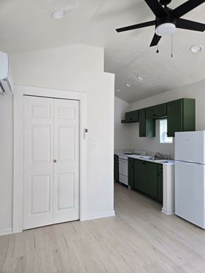 Hattiesburg apartment for rent - A white door is in a room with a ceiling fan.
