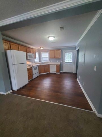Hattiesburg apartment for rent - an empty kitchen with wooden floors and a white refrigerator