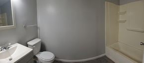 Hattiesburg apartment for rent - A bathroom with a toilet, sink, and bathtub.