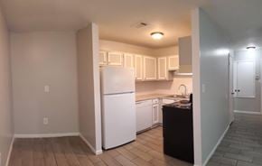 Hattiesburg apartment for rent - A kitchen with white appliances and wooden floors.